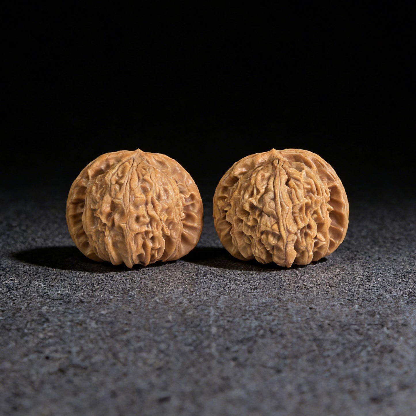 Walnut hand exerciser pair "Hidden Tip White Lion" by ThePatinaProject, 39mm x 37mm, showcasing intricate carved details.