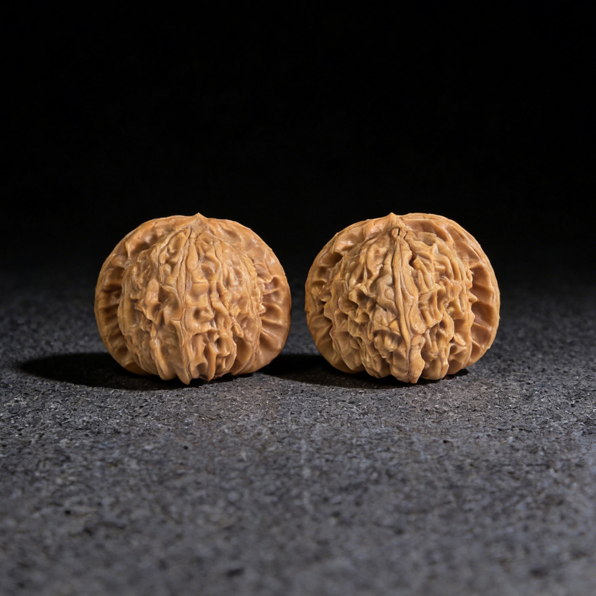 Walnut hand exerciser pair "Hidden Tip White Lion" by ThePatinaProject, 39mm x 37mm, showcasing intricate carved details.
