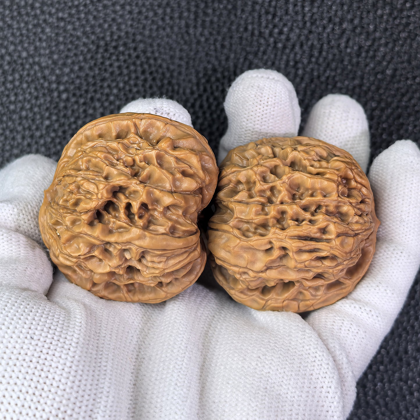 Walnut hand exercisers from ThePatinaProject, Hundred Longevity pair, 43mm x 39mm, showcasing textured wooden grips.