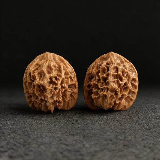 Pair of Walnut Hand Exercisers labeled Imperial Grand Flower by ThePatinaProject, 44mm diameter, shown in close-up.