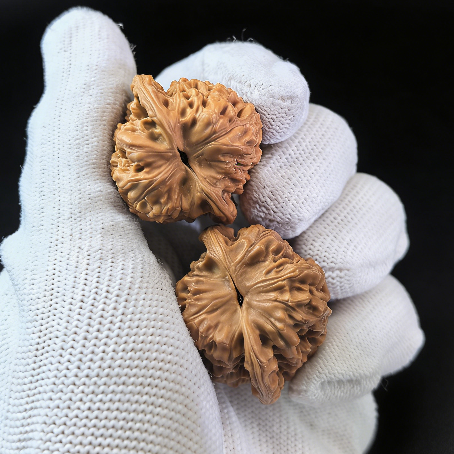Pair of walnut hand exercisers from ThePatinaProject's Imperial Micro-Guanmao collectors' hat, featuring intricate detailing.