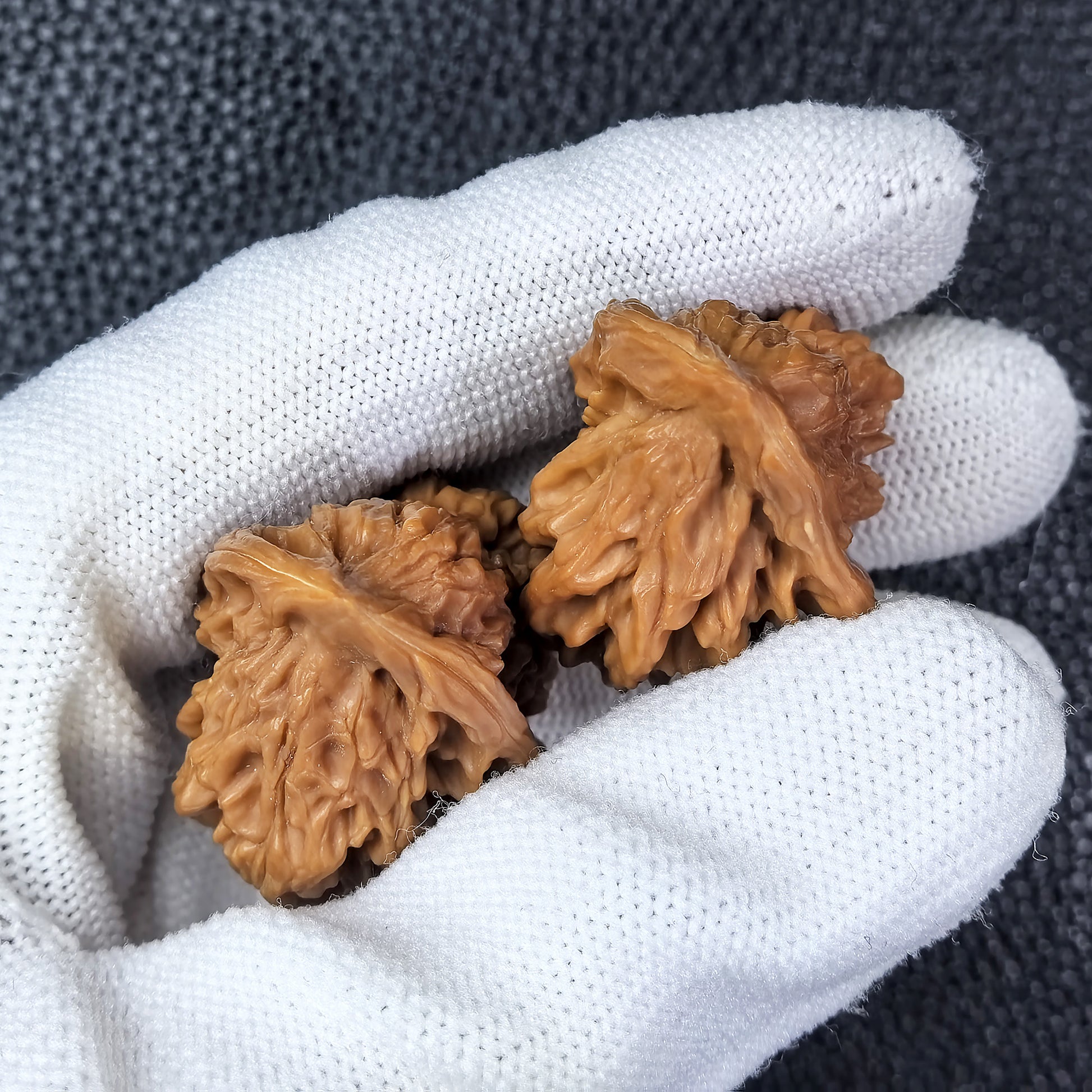 Pair of walnut hand exercisers featuring the Irregular Little Bird design by ThePatinaProject, measuring 25mm by 30mm.