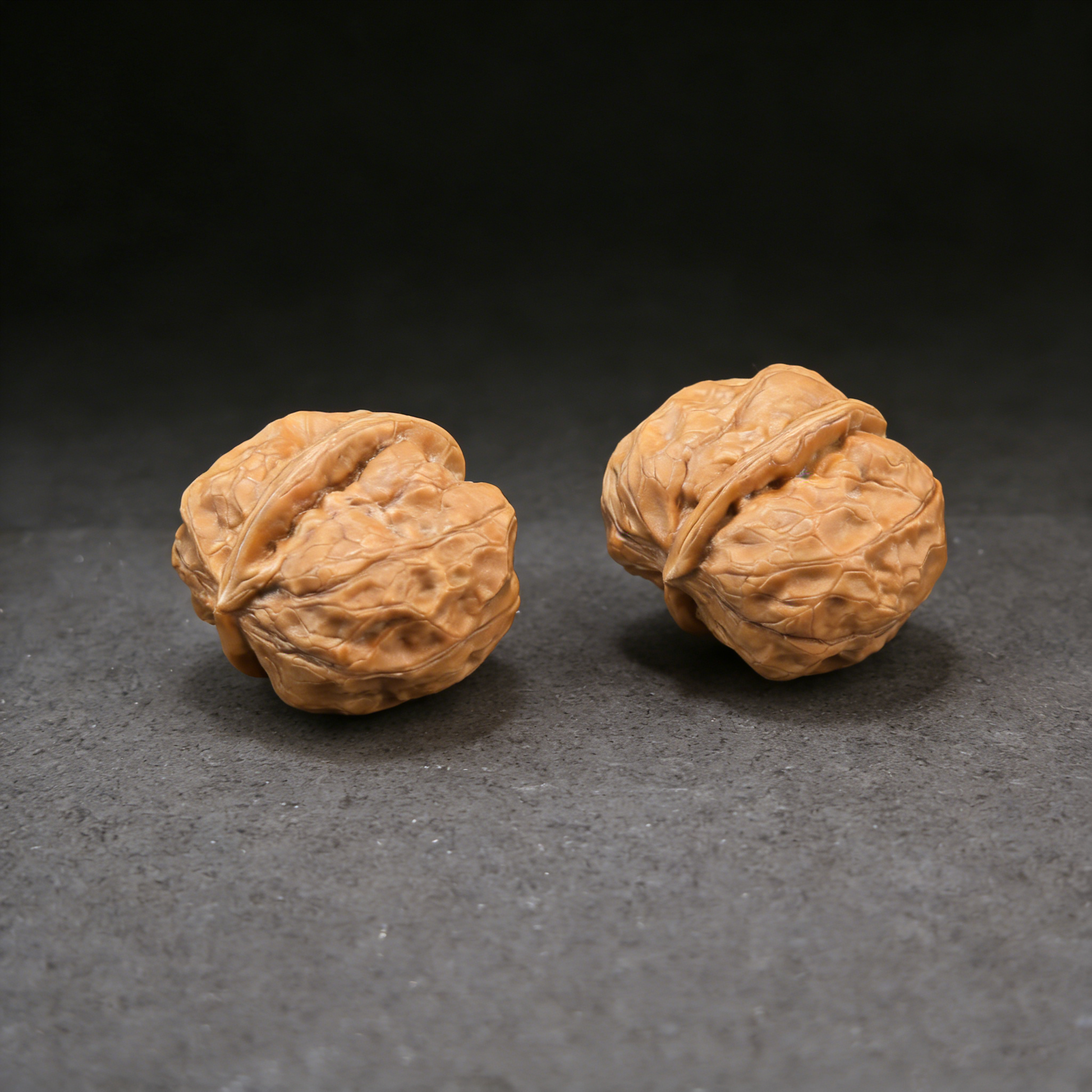 Walnut hand exercisers featuring a 31mm Jade Cicada crystal pair from ThePatinaProject, showcasing detailed miniature carvings.