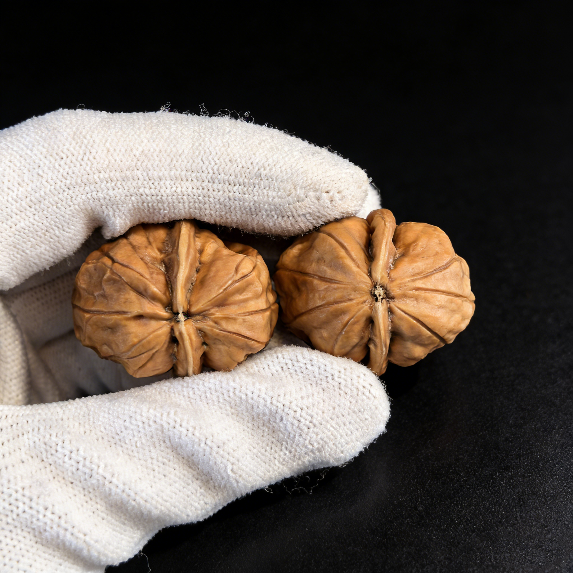 Pair of walnut hand exercisers with Jade Cicada crystals, featuring miniature, detailed textured design from ThePatinaProject.