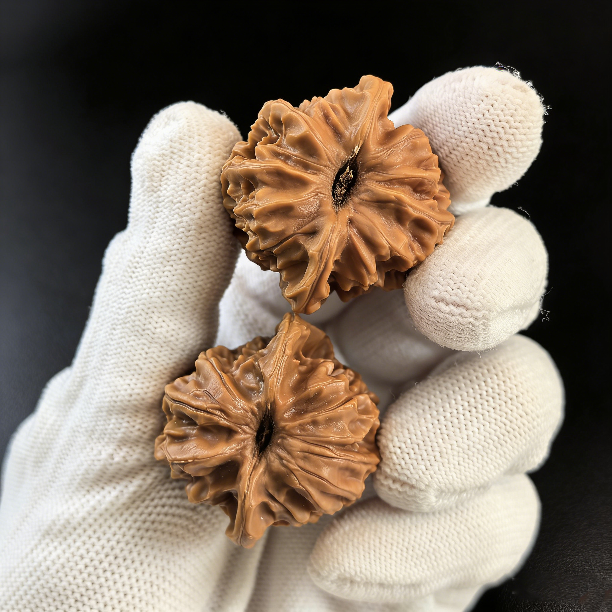 Pair of walnut hand exercisers shaped like lion heads from ThePatinaProject's Jade Seal collection, with intricate imperial-style carvings.