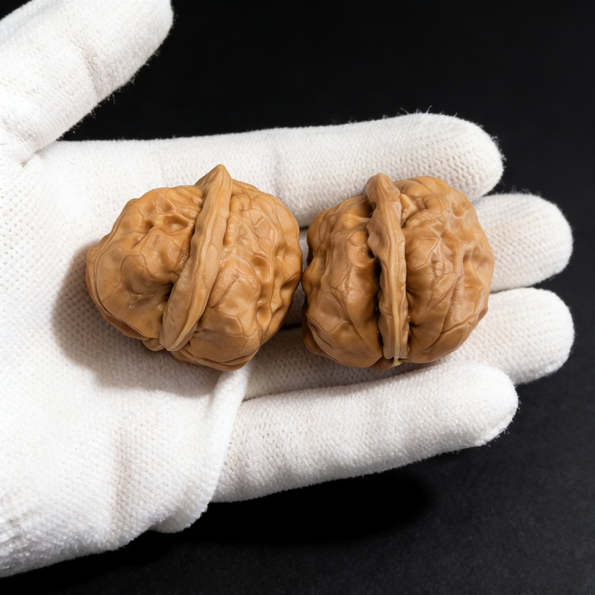 Walnut hand exercisers featuring the Jade Toad (Yu Chan) design, 28mm fingertip pair from ThePatinaProject's One Day Red minis collection.