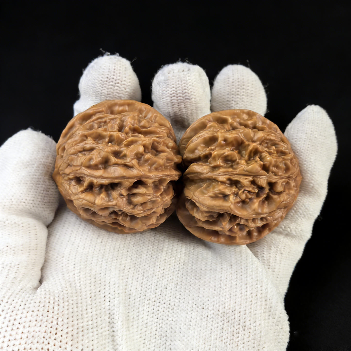 Pair of Jiu Long Yu walnut hand exercisers from ThePatinaProject, 40mm size, showing textured walnut wood and ergonomic design.