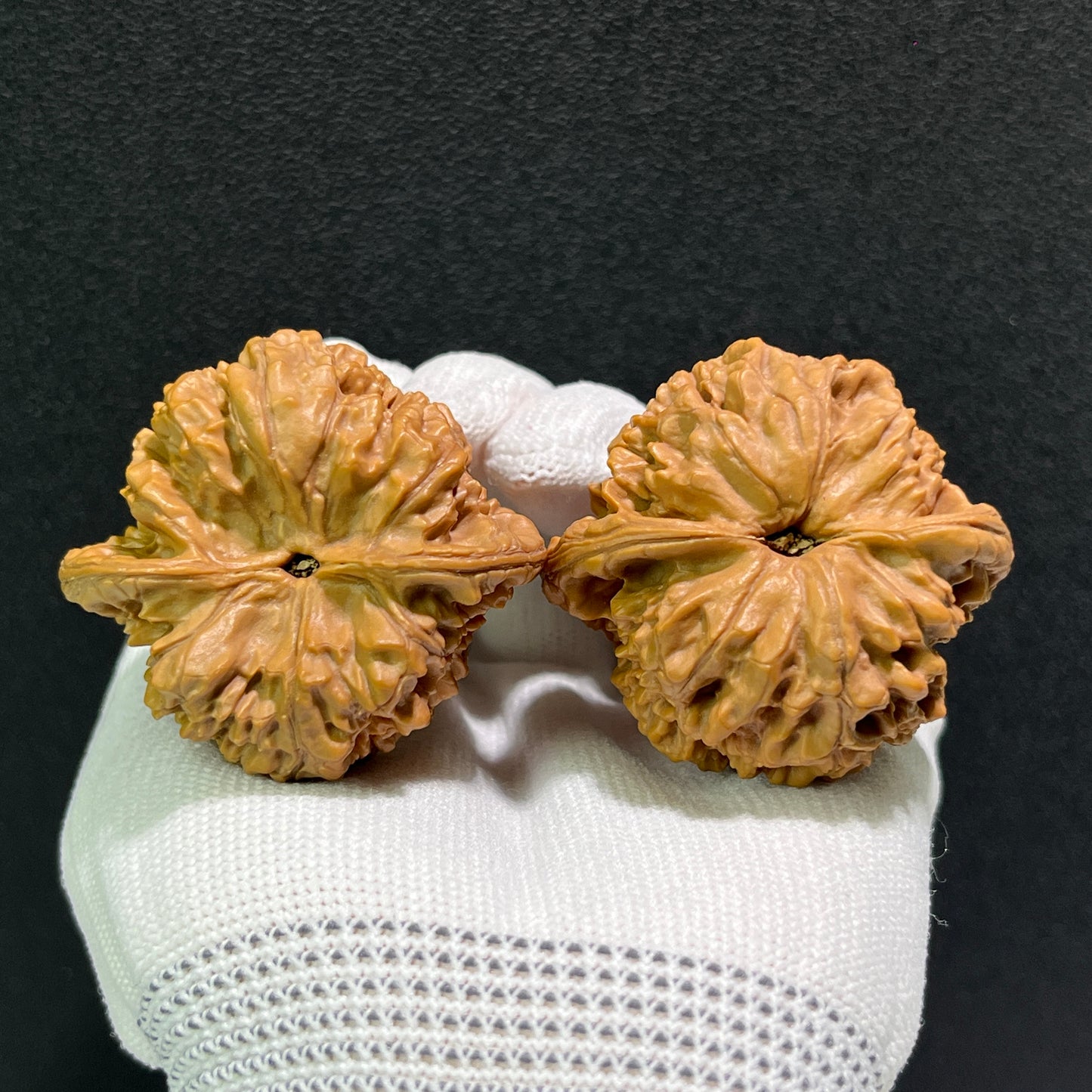 Walnut hand exerciser pair labeled Large Official's Hat (Da Guan Mao), 46mm x 42mm, from ThePatinaProject showing textured surface.