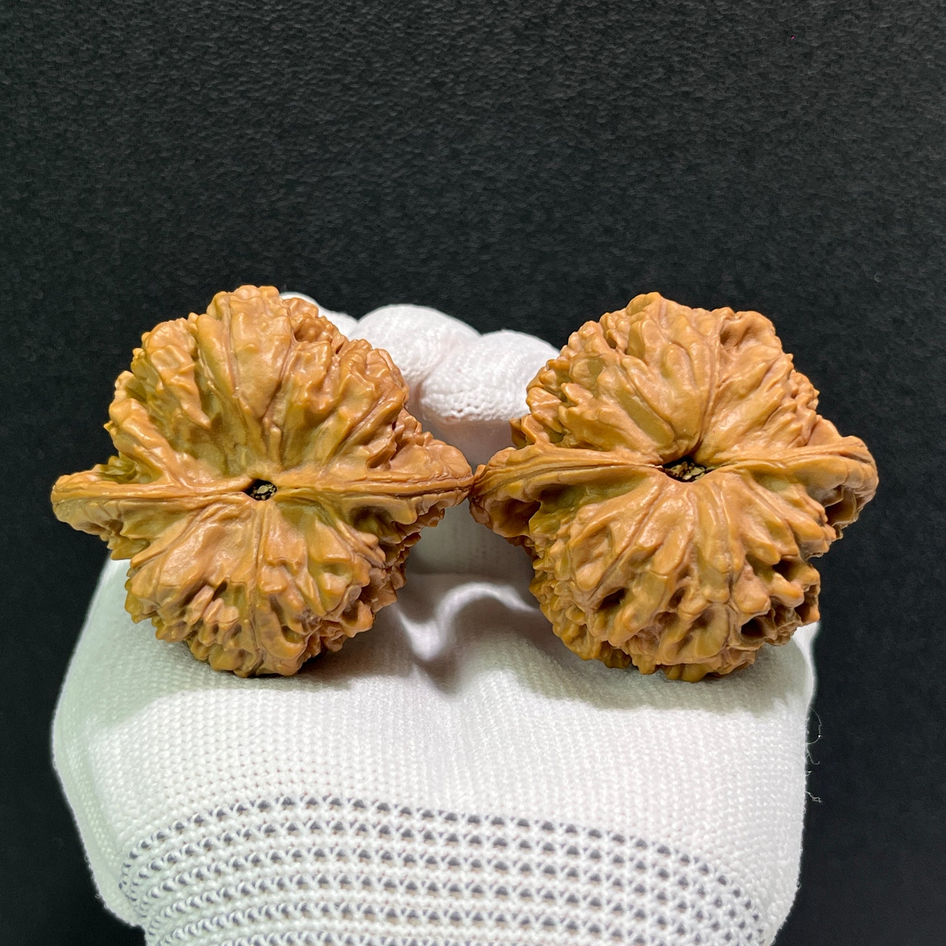 Walnut hand exerciser pair labeled Large Official's Hat (Da Guan Mao), 46mm x 42mm, from ThePatinaProject showing textured surface.