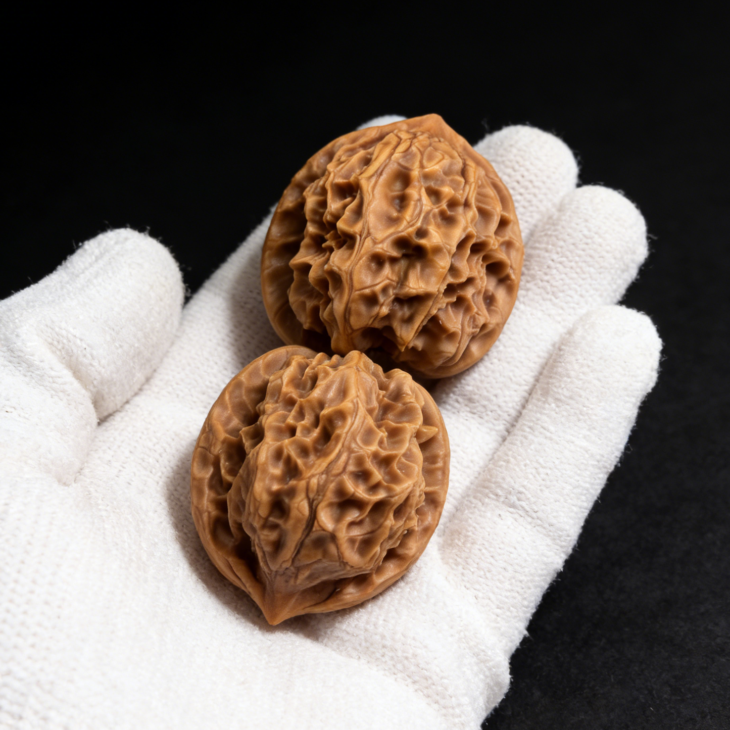 Walnut hand exerciser featuring miniature hearts, 33mm "Ling Long" pocket pair by ThePatinaProject, shown in the image.