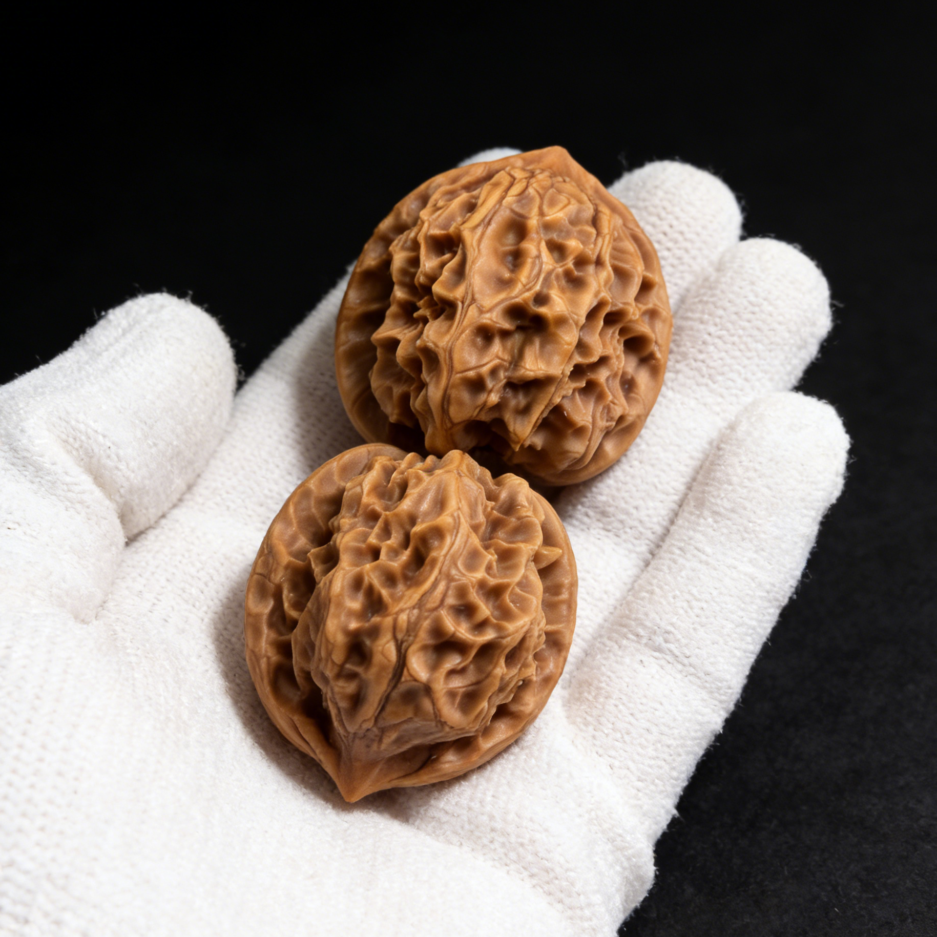 Walnut hand exerciser featuring miniature hearts, 33mm "Ling Long" pocket pair by ThePatinaProject, shown in the image.