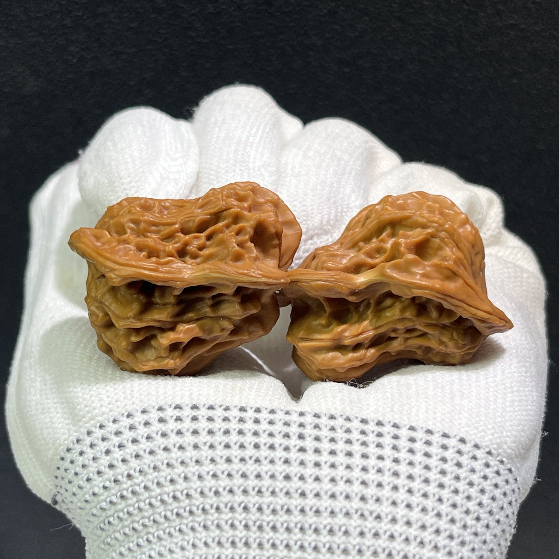 Walnut hand exerciser pair called "Little Bird" by ThePatinaProject, featuring 35mm x 28mm size, ergonomic design for grip training.