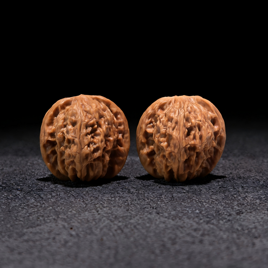 Pair of Walnut Millstone hand exercisers from ThePatinaProject, 37mm x 37mm, designed for grip strength training.
