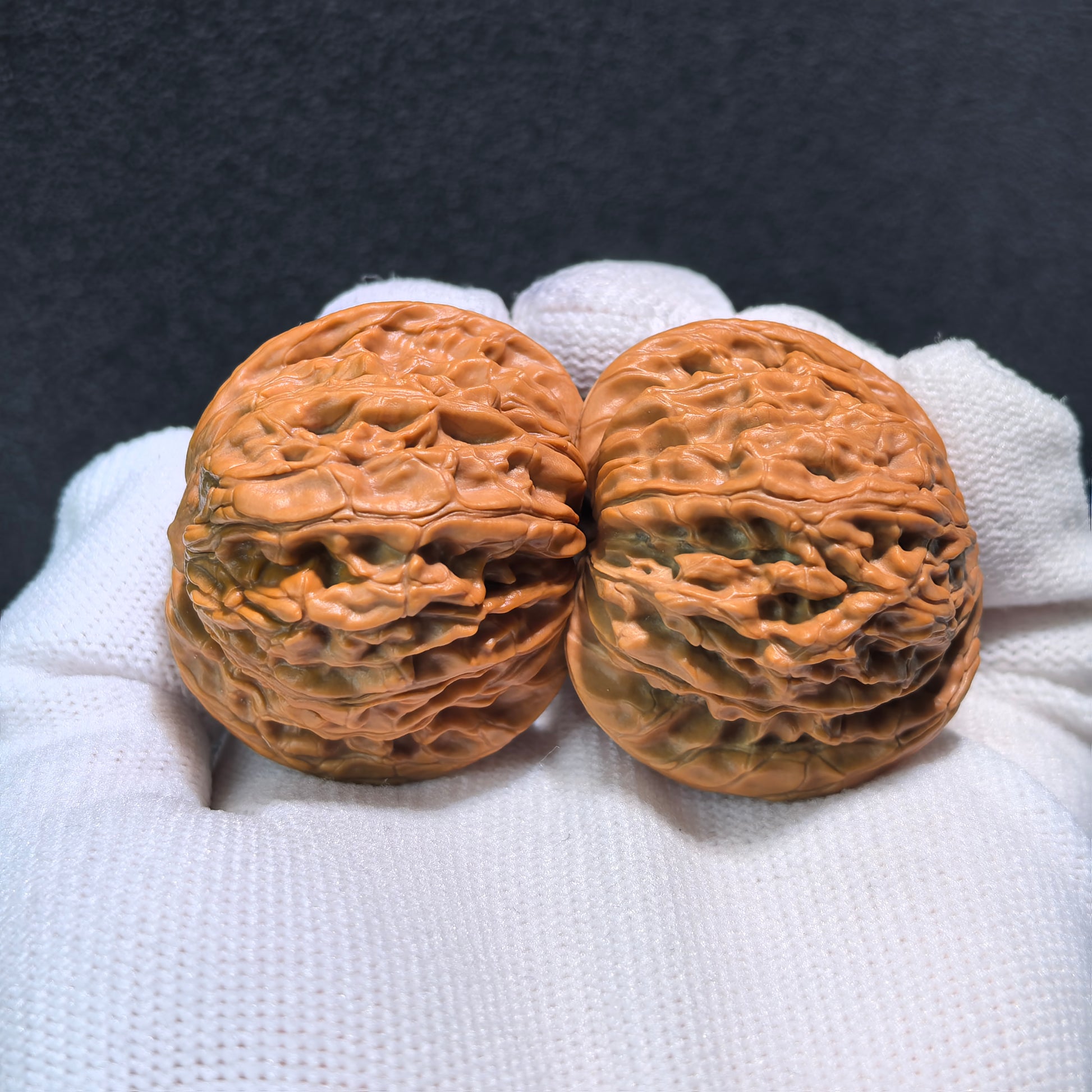 Pair of Walnut Hand Exercisers called Millstone (Mo Pan) by ThePatinaProject, measuring 39mm x 36mm for grip strength training.