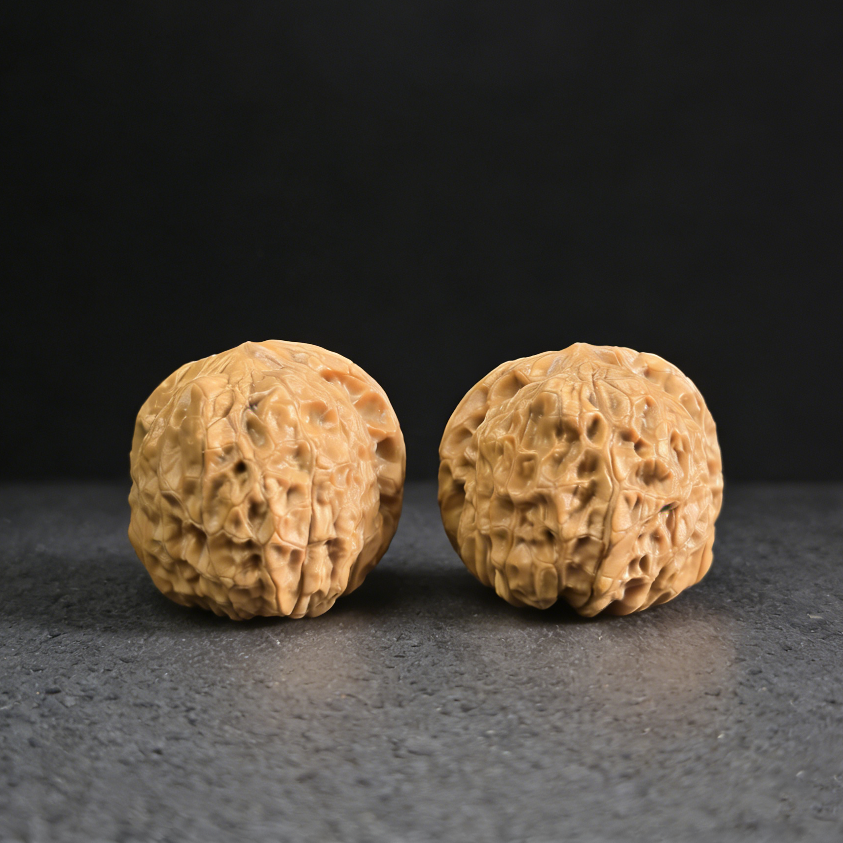 Walnut hand exercisers featuring the Nan Gua Dun design, 37mm size, from ThePatinaProject, showcasing carved pumpkin pattern on wood