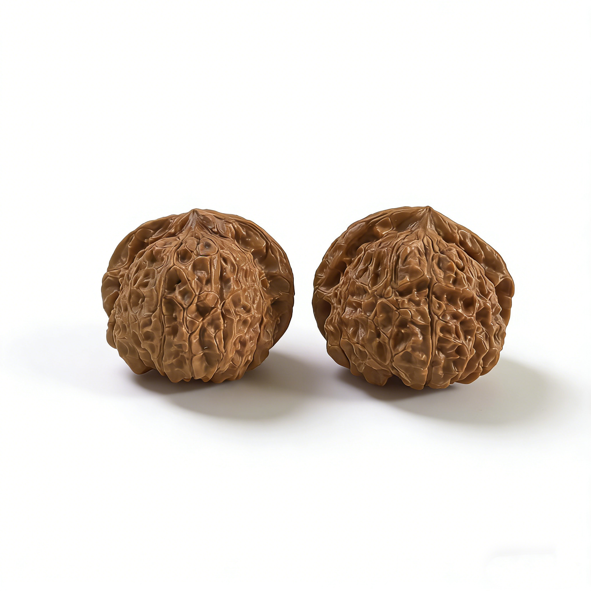 Walnut hand exerciser pair shaped like pumpkins, 40mm size, from ThePatinaProject Nan Gua Dun collection, showing textured surface.