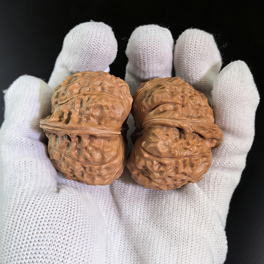 Walnut hand exerciser pair labeled "Nan Gua Dun" 40mm by ThePatinaProject, featuring natural wood grain and ergonomic design.