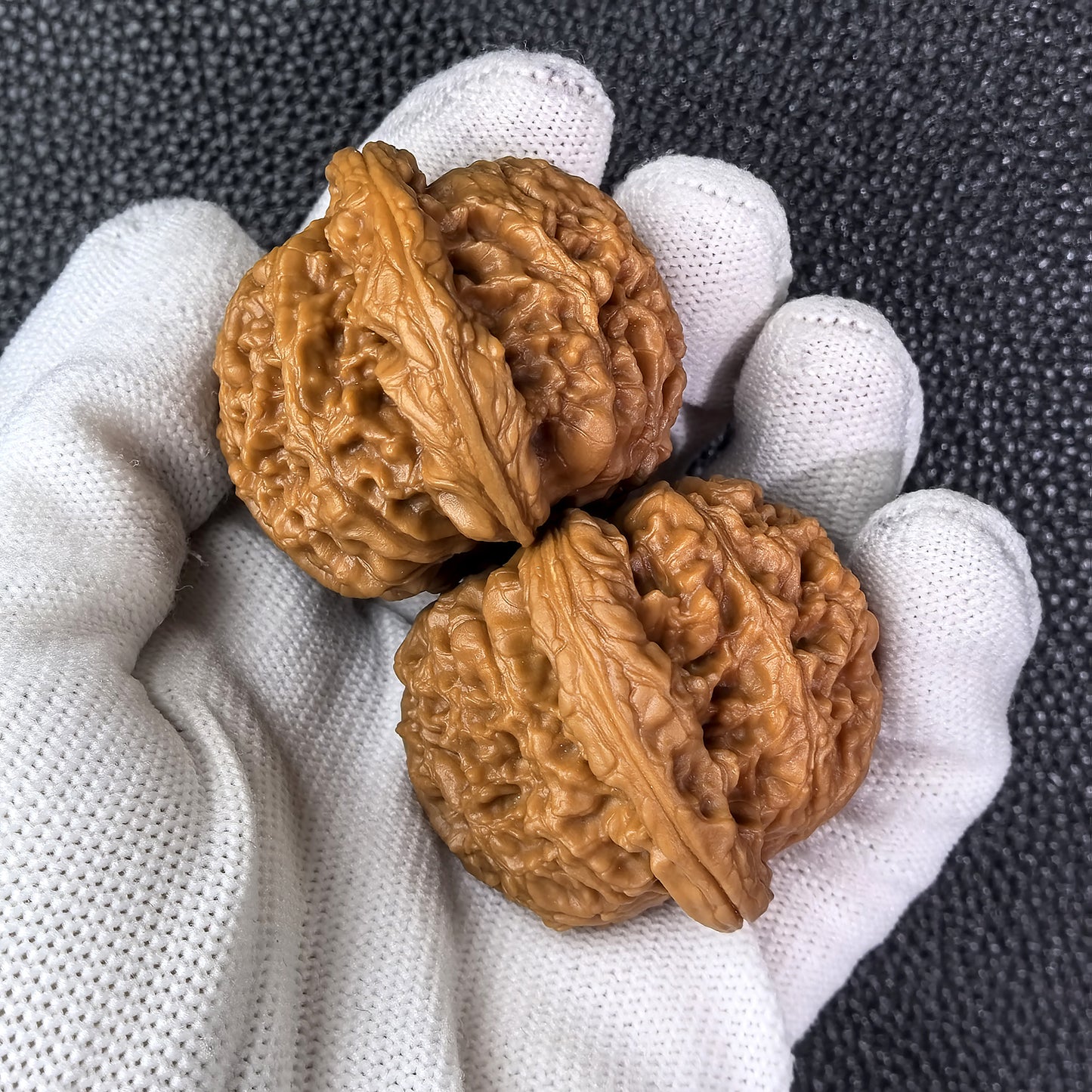 Pair of Nan Jiang Stone walnut hand exercisers by ThePatinaProject, measuring 45mm x 41mm, with smooth, polished finish.