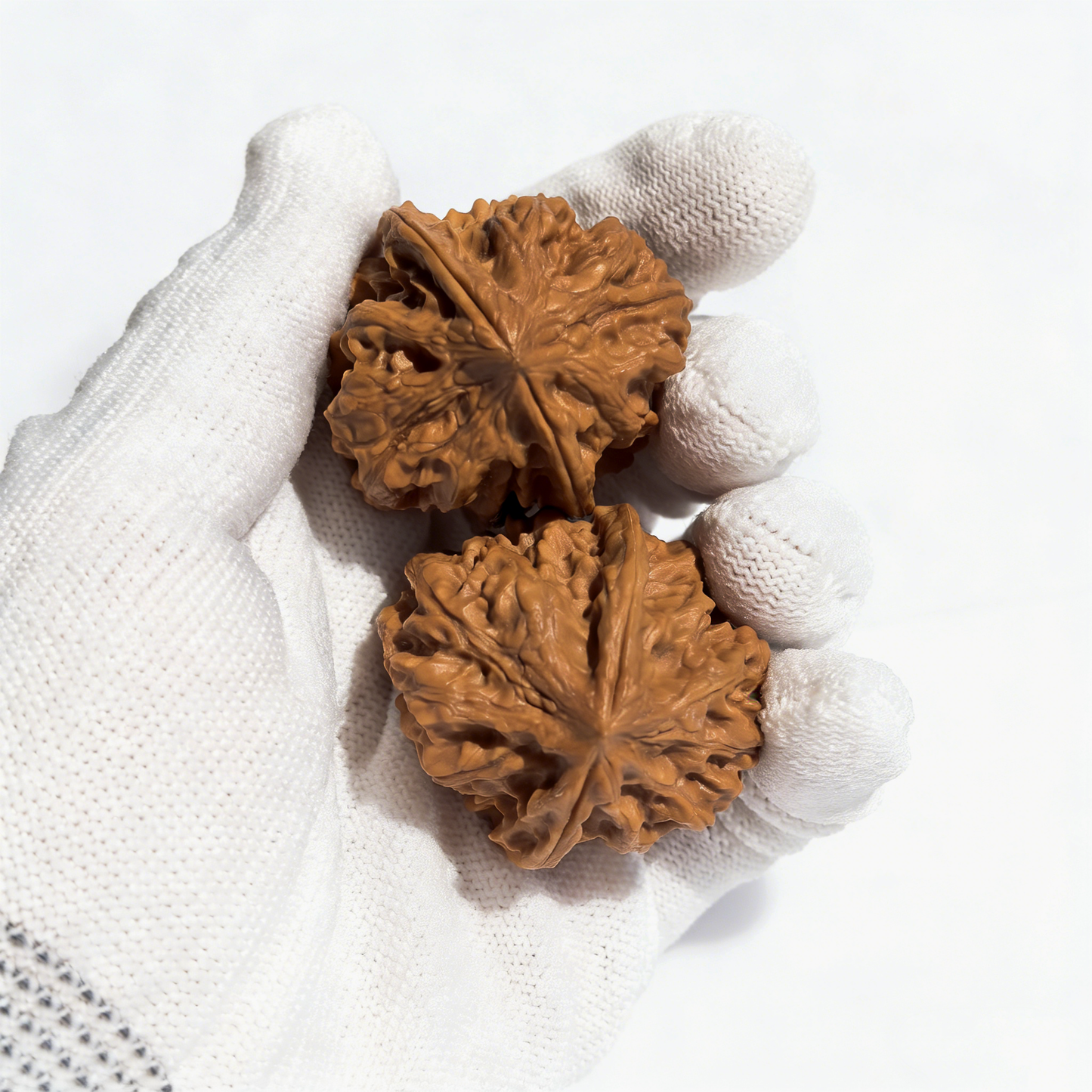 Pair of walnut hand exercisers featuring intricate "Nine Dragon Sinews" design and "Dragon Bone" architecture, 38mm diameter.