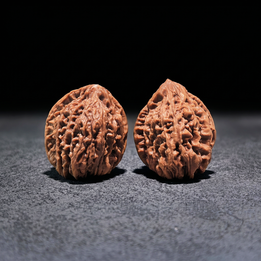 Pair of Nine Dragons Thick Ridge Walnut Hand Exercisers by ThePatinaProject, 40mm x 42mm, with textured ridged surface for grip.