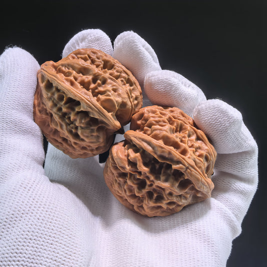 Pair of walnut hand exercisers from ThePatinaProject's Nine Dragons Valley collection, 36mm x 39mm, JLY-703, with intricate dragon carvings.