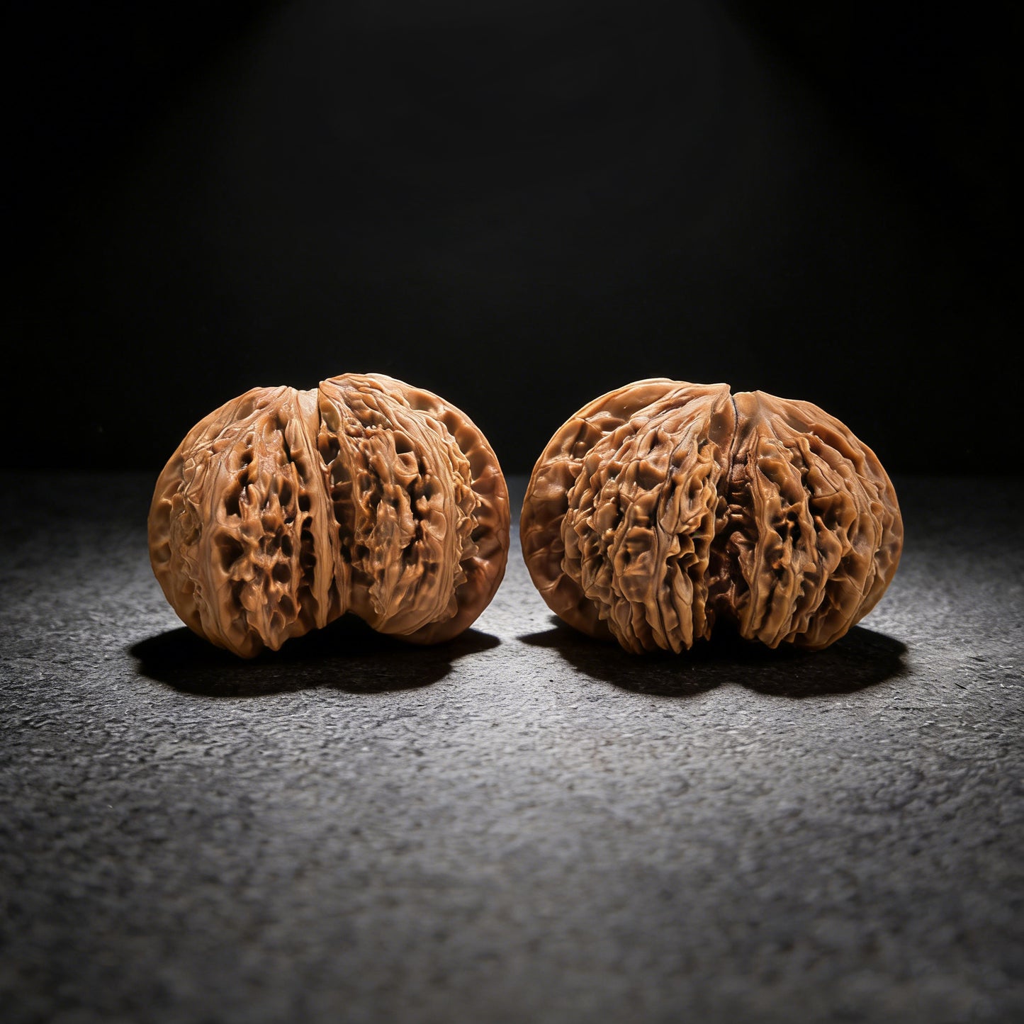 Pair of walnut hand exercisers from ThePatinaProject's NJS Conjoined Twin collection, 54mm by 38mm, premium grade.