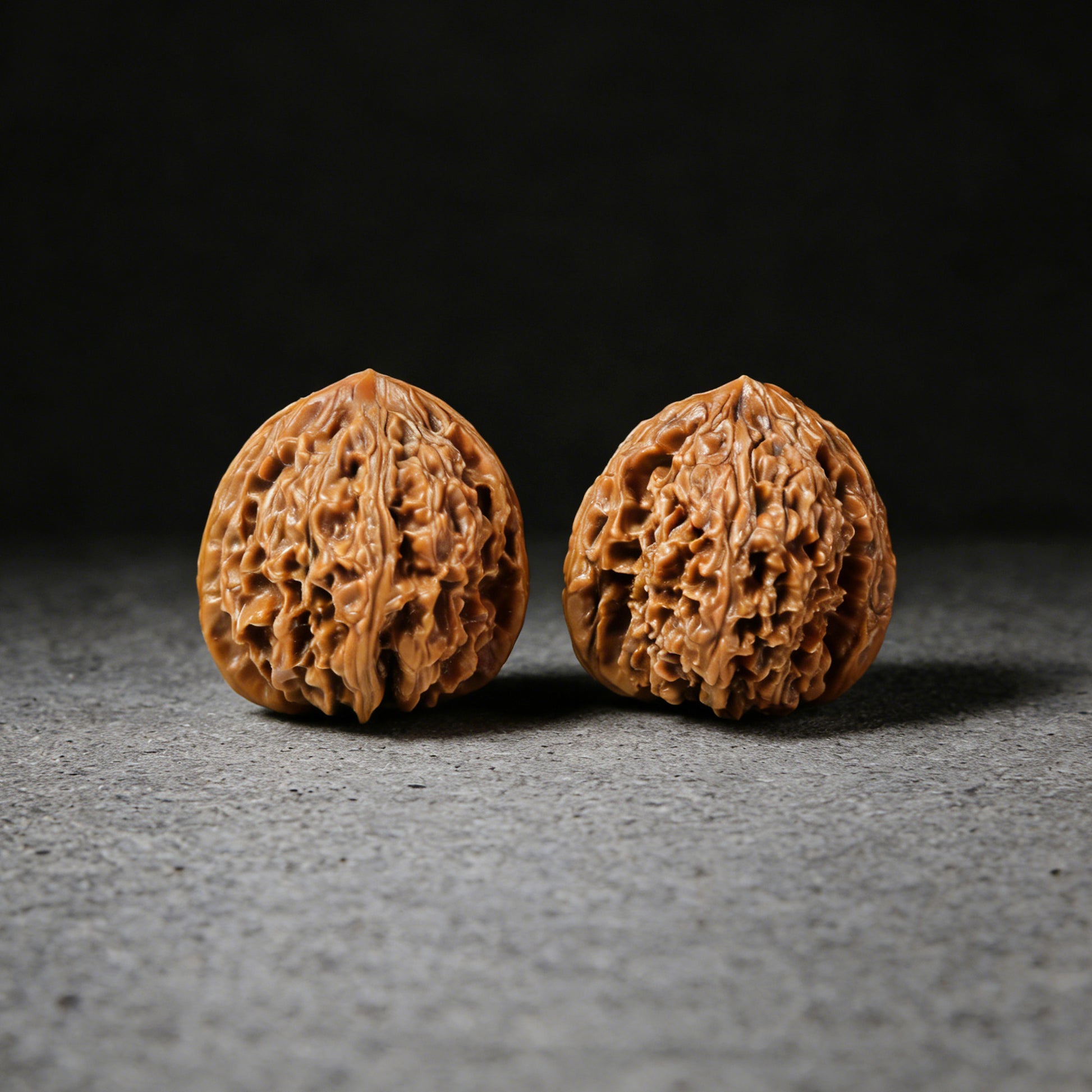 Pair of Old Tree Red Skin Nan Jiang Shi walnut hand exercisers by ThePatinaProject, 35mm diameter, showing textured red-brown surface.