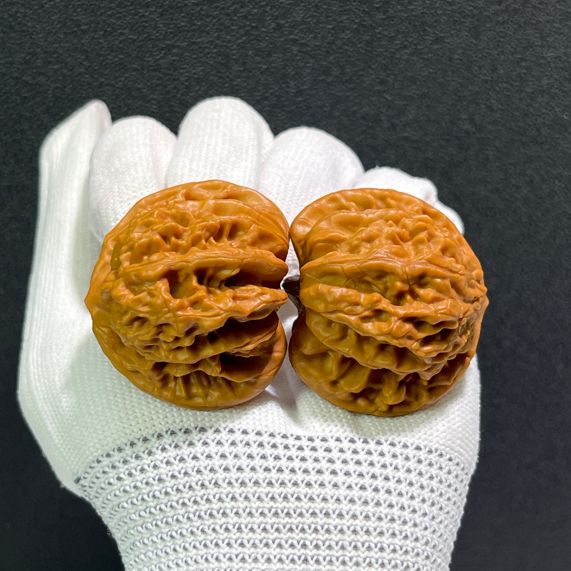 Pair of Peach Heart Xia Yun Ling walnut hand exercisers by ThePatinaProject, 40mm x 36mm, featuring intricate carved heart designs.