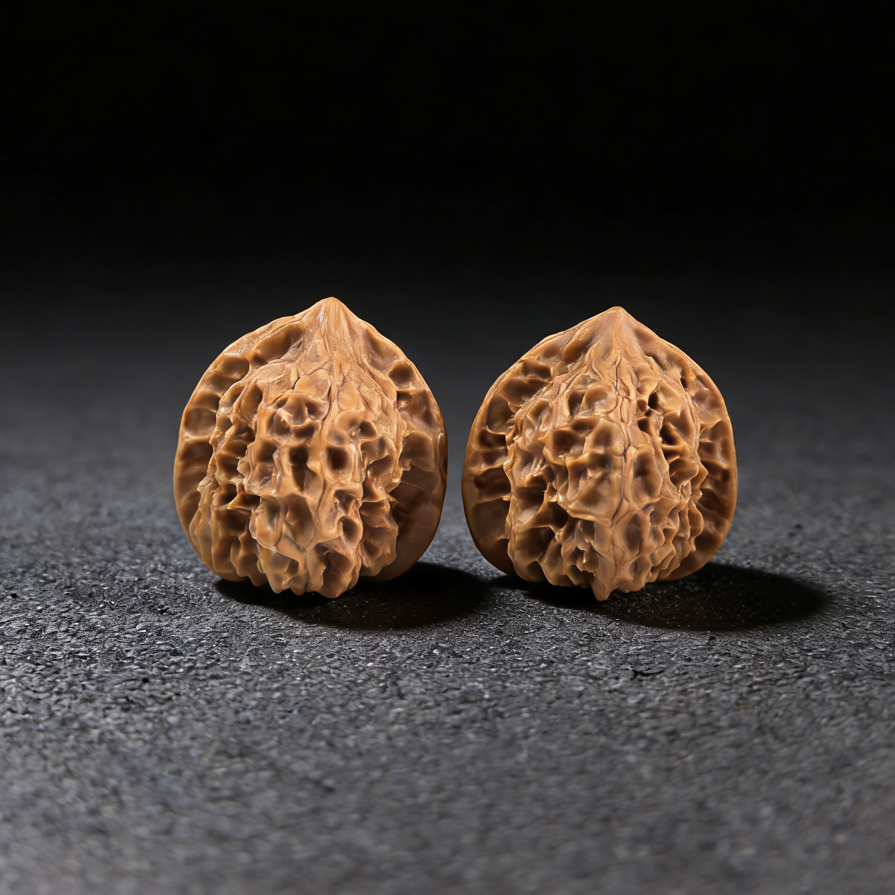 Walnut hand exercisers from ThePatinaProject, Petite Ling Long Exquisite pair, 31mm size, showing smooth walnut finish and ergonomic design.