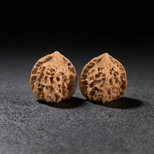 Walnut hand exercisers from ThePatinaProject, Petite Ling Long Exquisite pair, 31mm size, showing smooth walnut finish and ergonomic design.