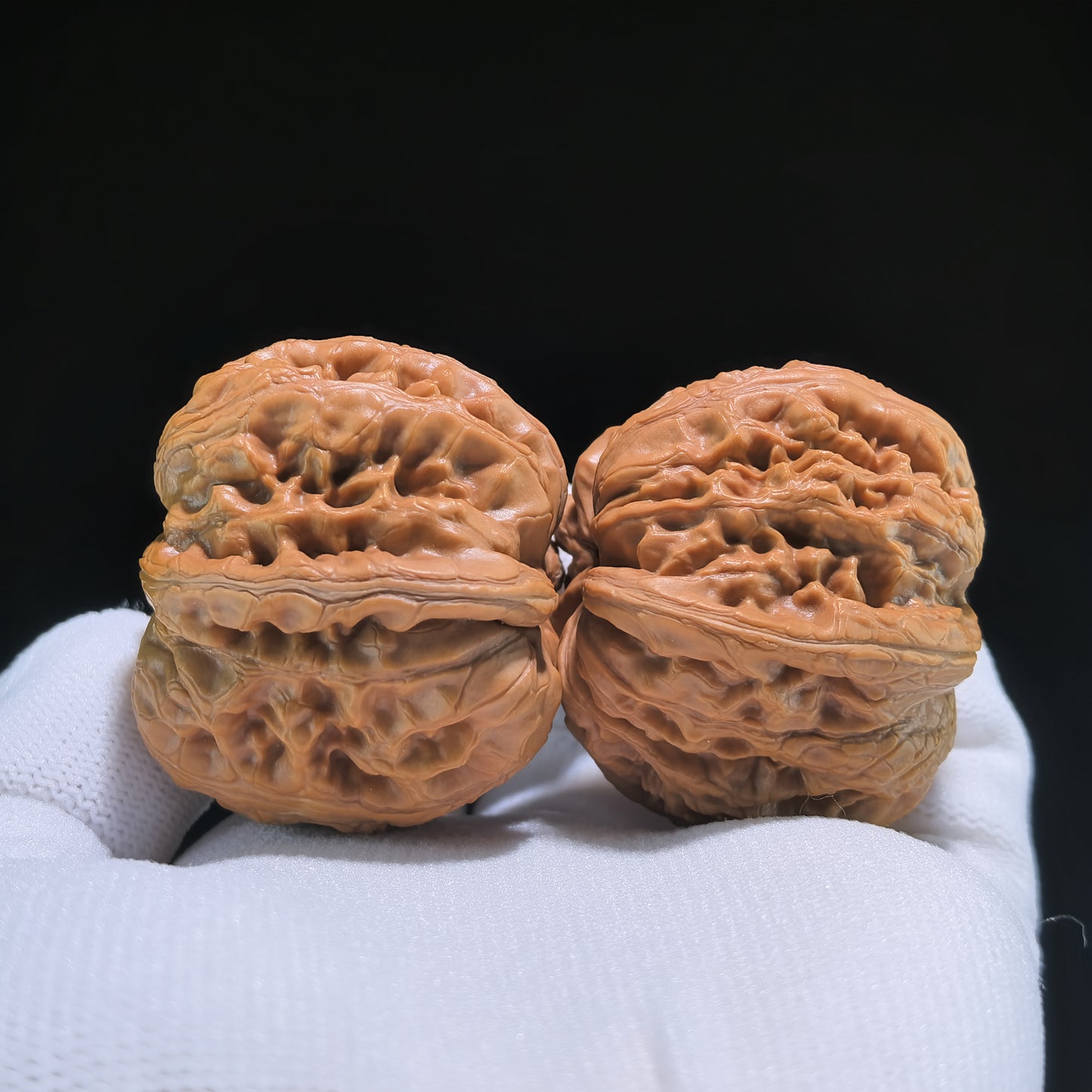 Pair of Pinggu Ingot walnut hand exercisers from ThePatinaProject, 39mm x 42mm, showing smooth polished walnut wood handles.