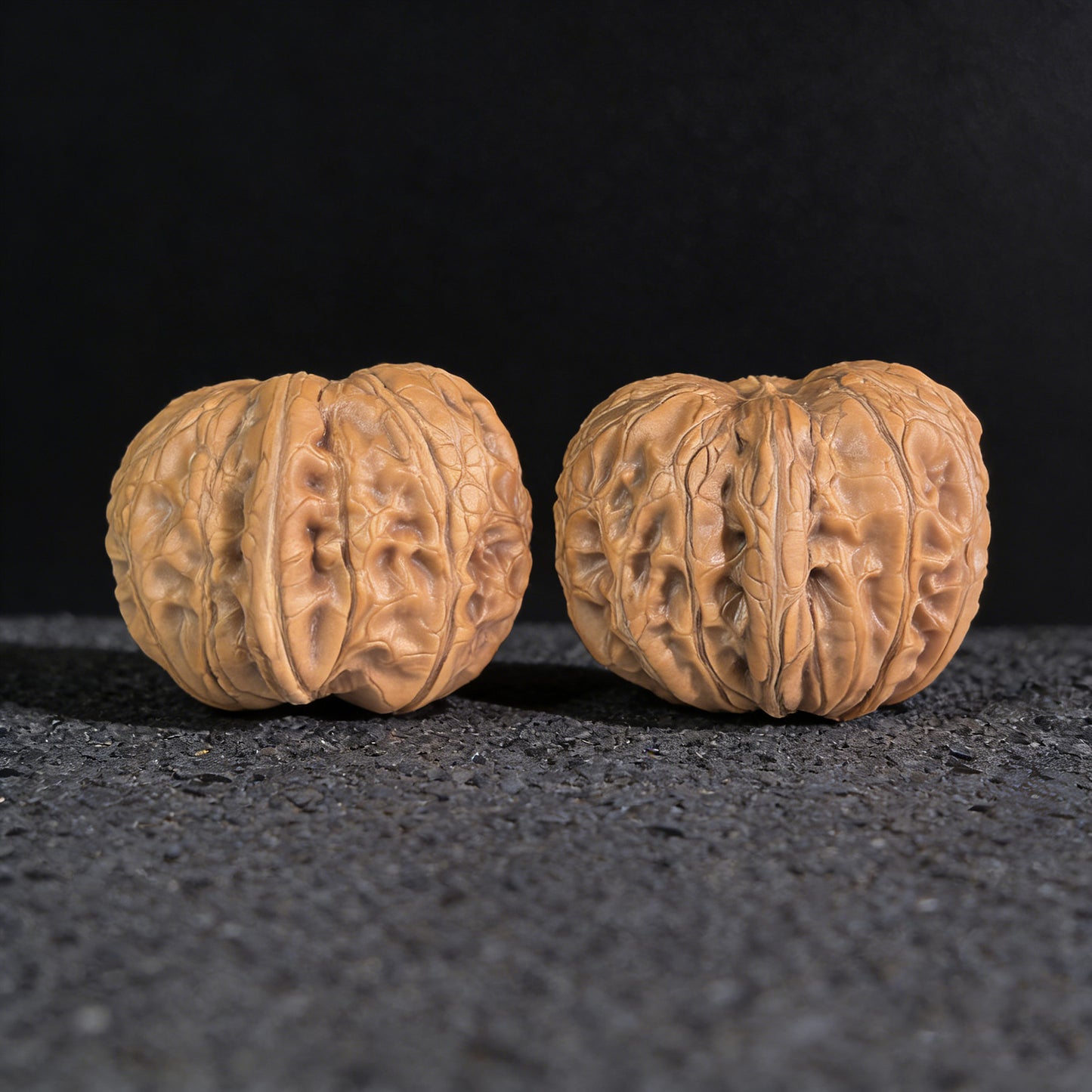 Pair of Pinggu Ingot walnut hand exercisers from ThePatinaProject, 33mm x 37mm, with smooth polished surfaces and traditional design.