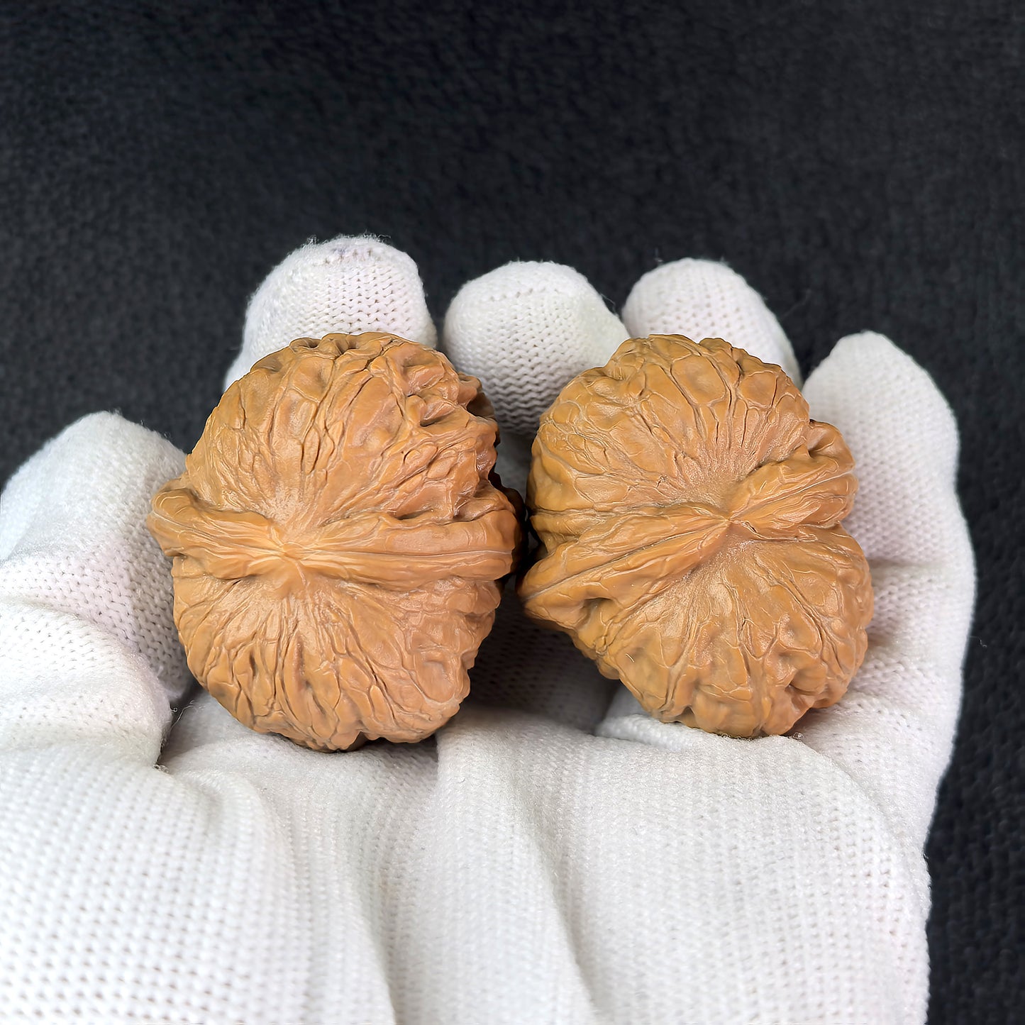 Pair of Pinggu Ingot walnut hand exercisers by ThePatinaProject, measuring 35mm x 39mm, showcasing polished wooden texture.