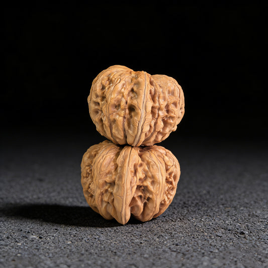 Pair of Pinggu Ingot walnut hand exercisers from ThePatinaProject, 39mm x 42mm, showcasing polished wooden textures.