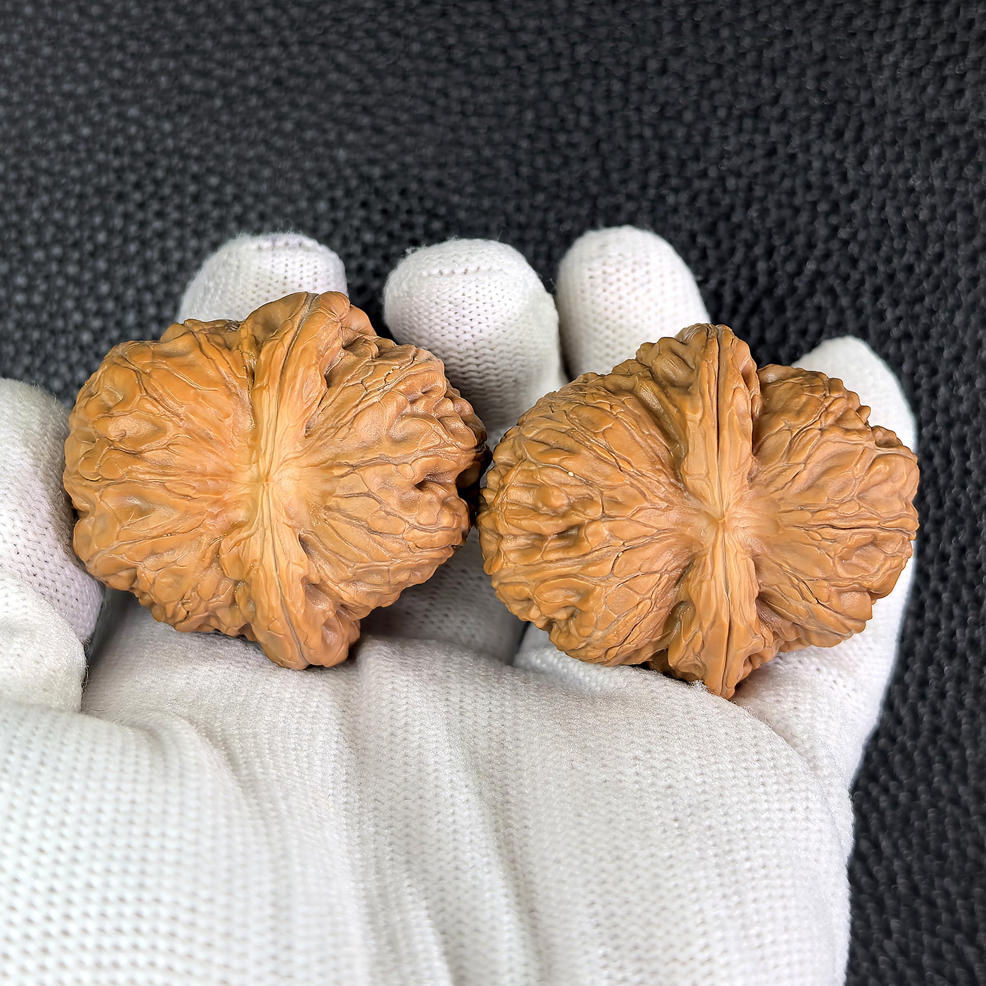 Pair of Pinggu Ingot walnut hand exercisers from ThePatinaProject, featuring 39mm by 42mm dimensions, crafted for grip training.