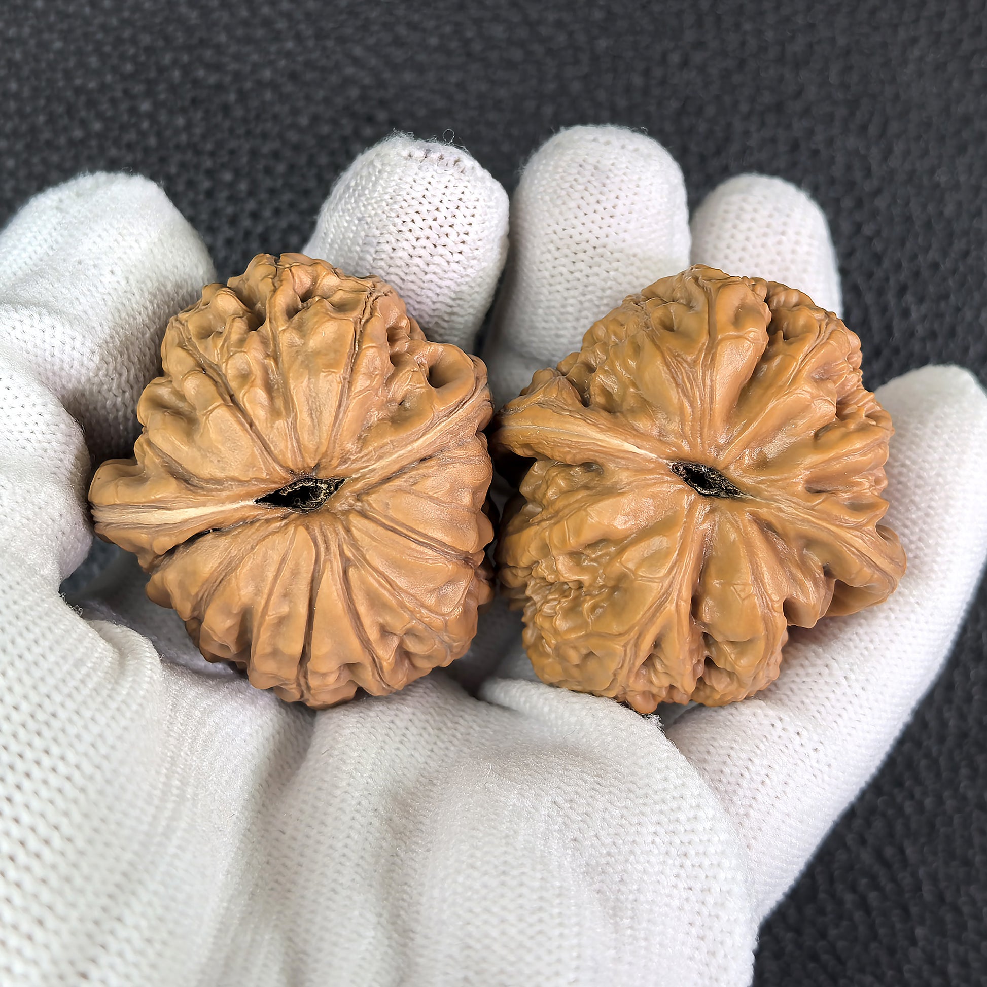Pair of Pinggu Ingot walnut hand exercisers from ThePatinaProject, measuring 39mm x 42mm, designed for hand strengthening.
