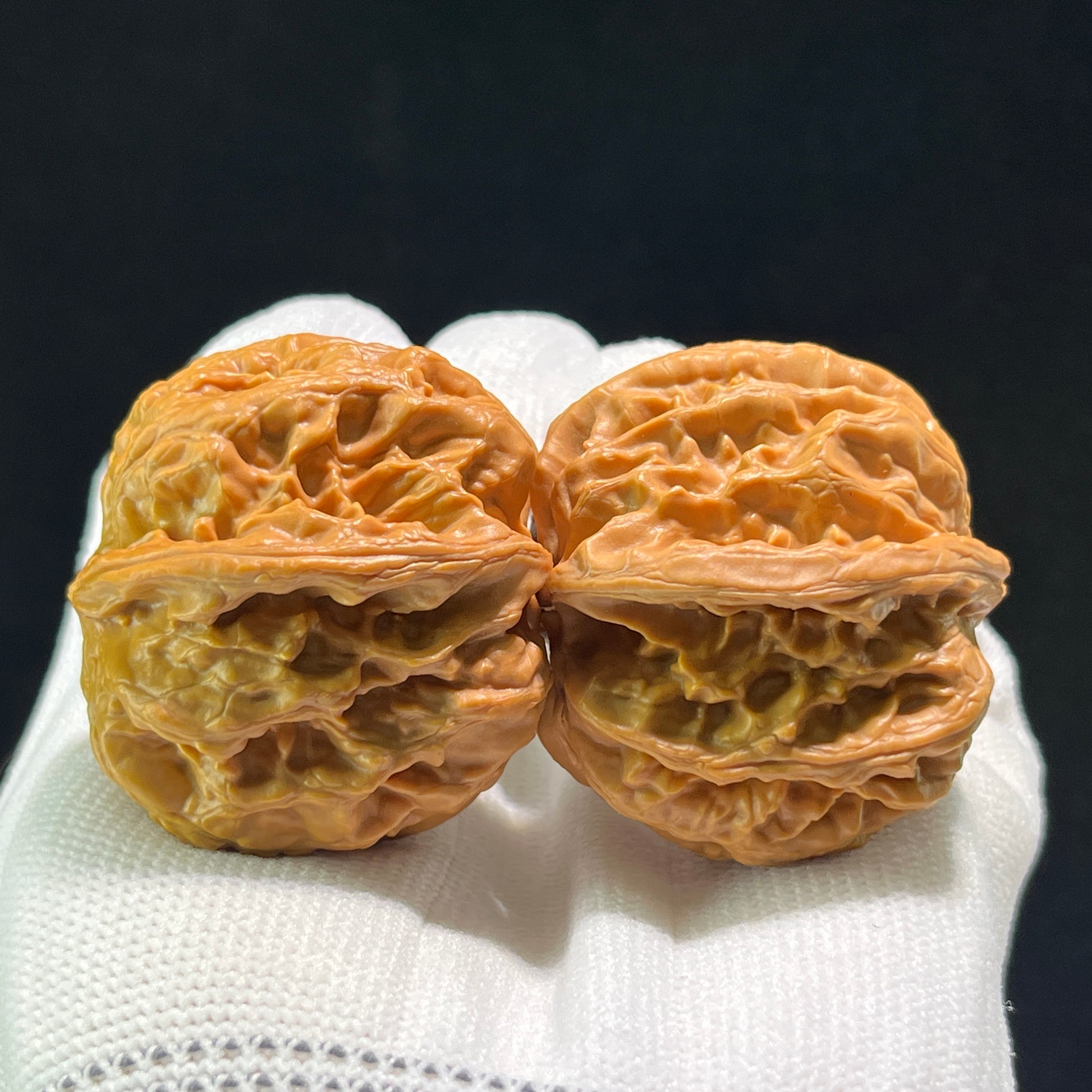 Pair of Pinggu "Square Box" walnut hand exercisers, 33mm x 40mm, from ThePatinaProject, showing textured wooden surfaces.