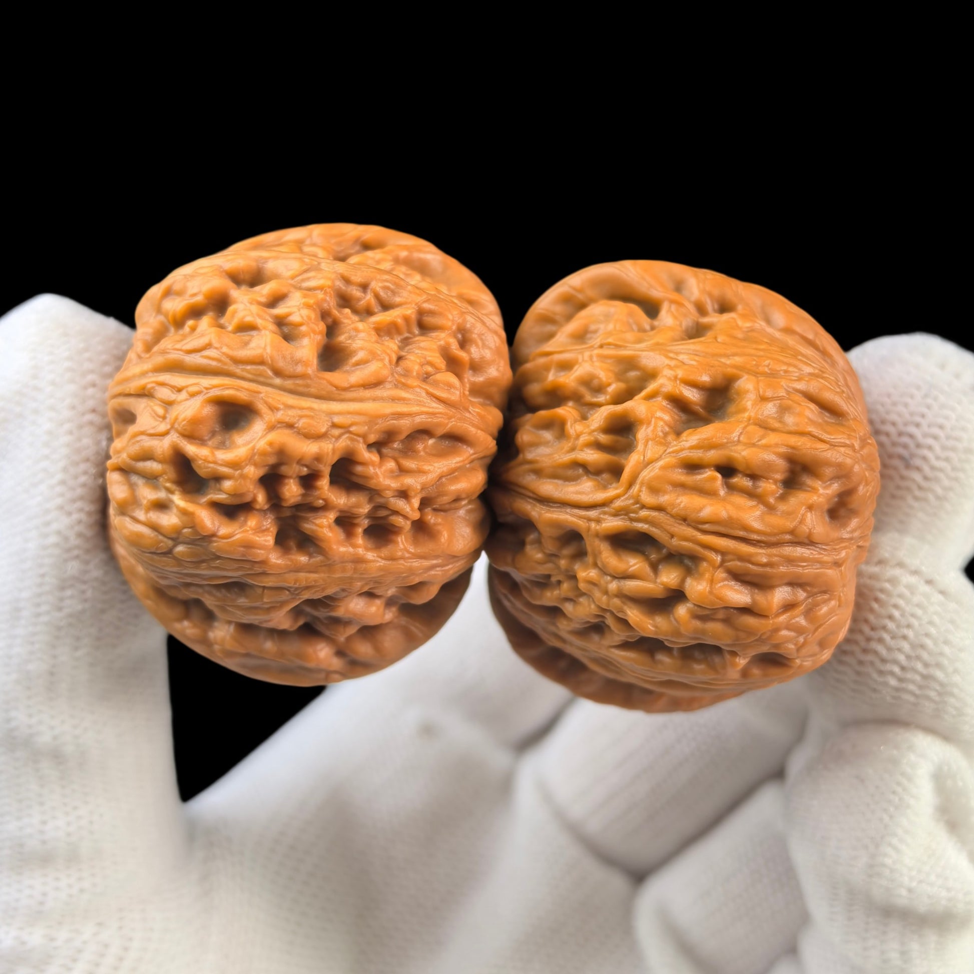 Pair of Pinggu Yuanbao walnut hand exercisers by ThePatinaProject, 40mm gold ingot-shaped grip tools for hand strengthening.