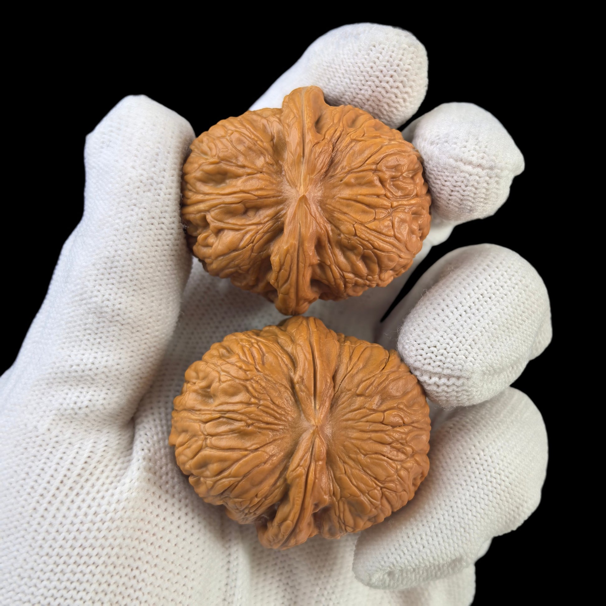 Pair of Walnut Hand Exercisers shaped like Pinggu Yuanbao gold ingots, 40mm, by ThePatinaProject, shown in natural wood finish.
