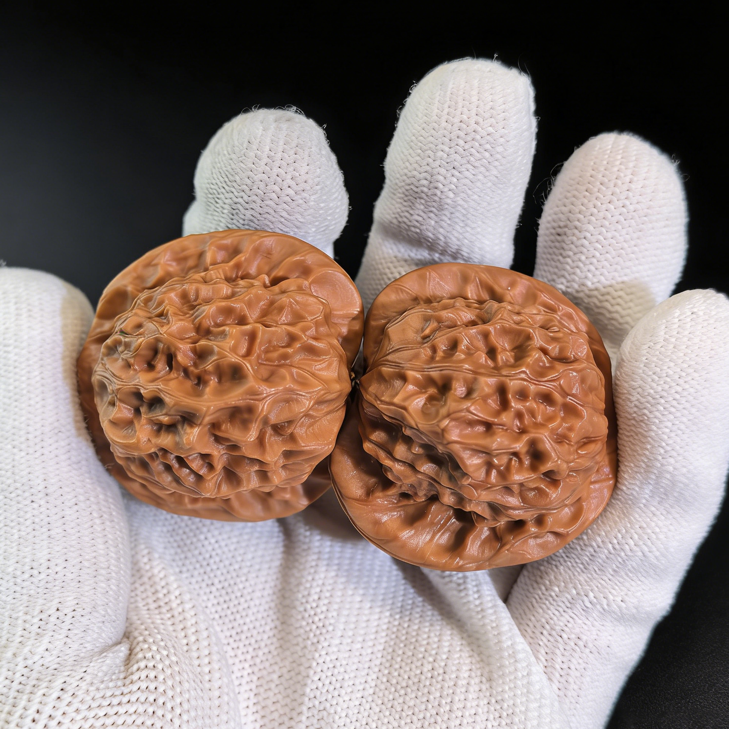 Walnut hand exercisers featuring porcelain doll design with waxy luster, 38mm collector’s pair by ThePatinaProject