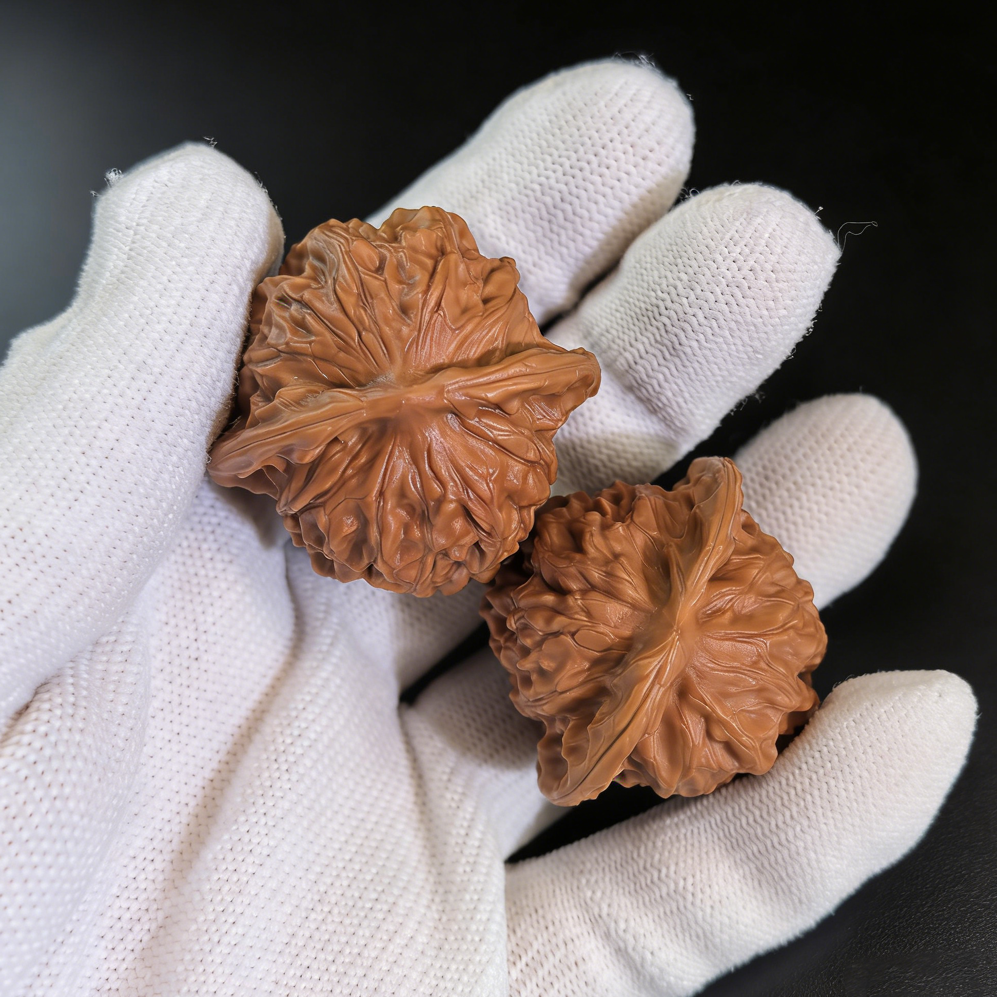 Pair of walnut hand exercisers shaped like porcelain dolls with refined elegance and waxy luster, 38mm collector’s set by ThePatinaProject.