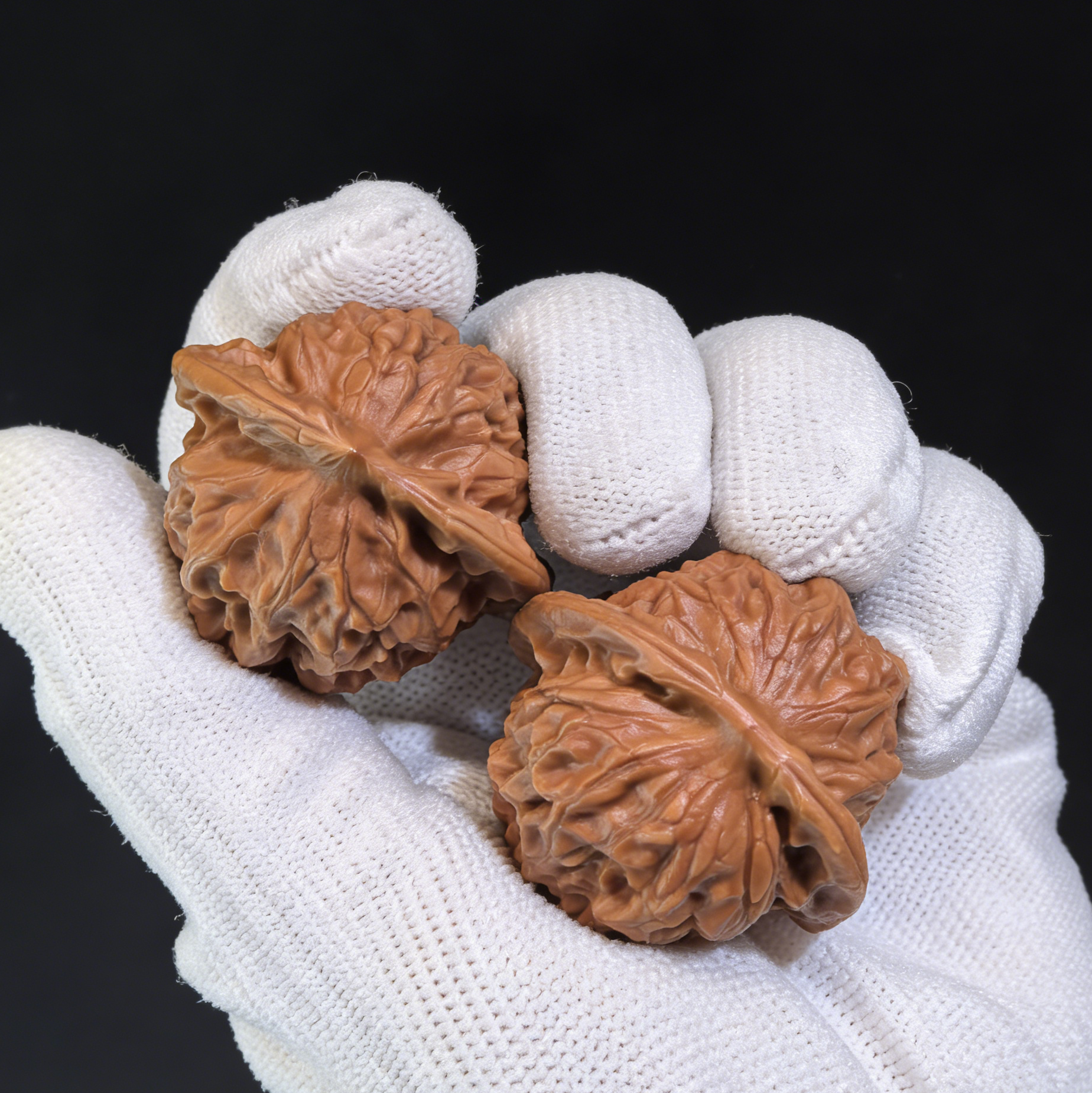 Walnut hand exercisers with porcelain doll design, featuring refined elegance and waxy luster, 38mm collector’s pair by ThePatinaProject.
