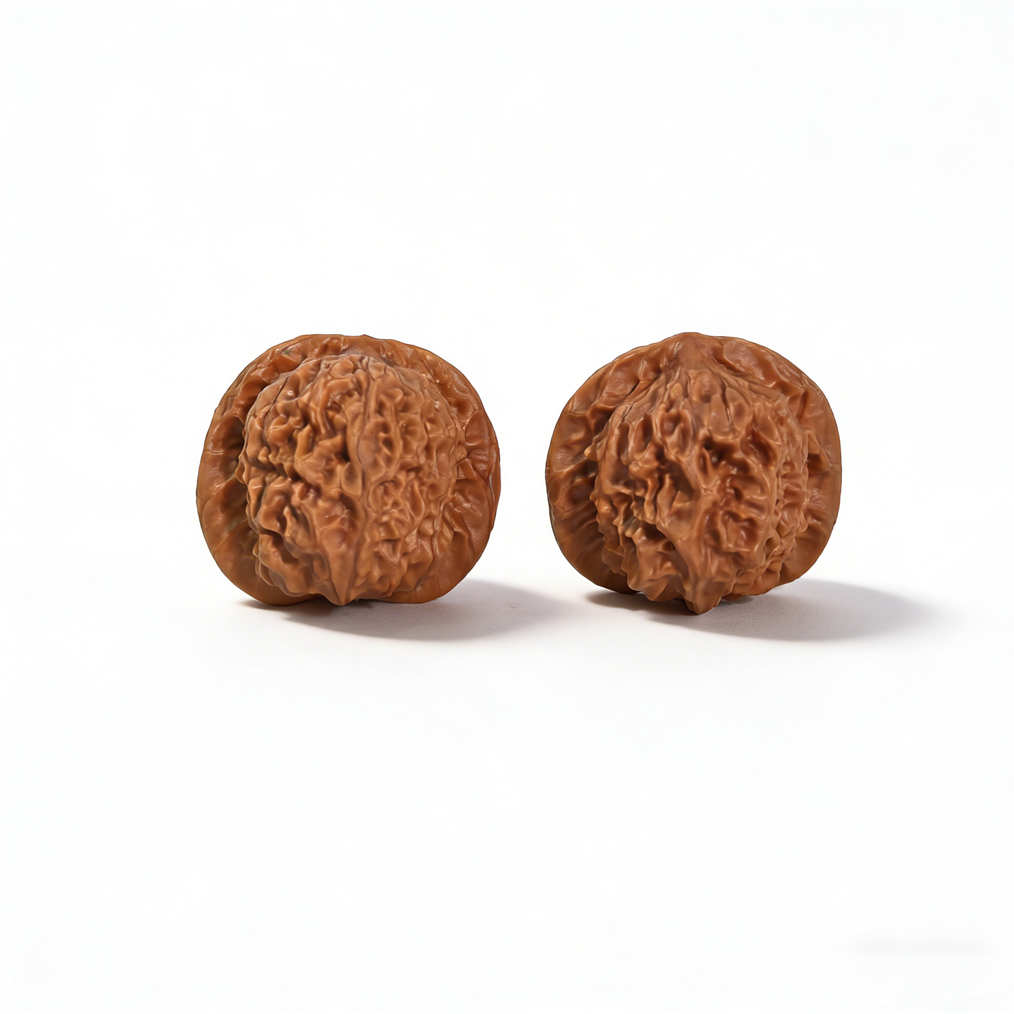 Walnut hand exerciser featuring porcelain doll design with waxy luster, 38mm collector’s pair by ThePatinaProject.