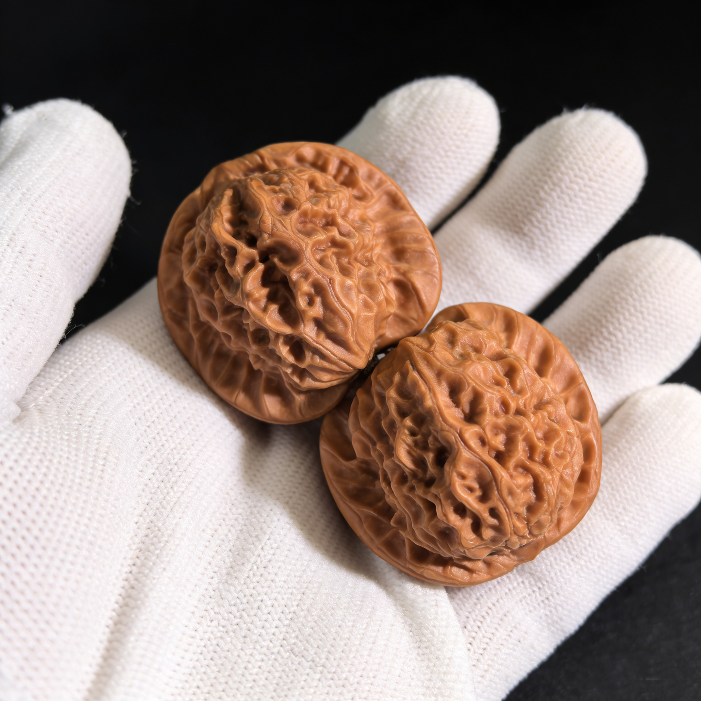 Walnut hand exercisers by ThePatinaProject featuring porcelain doll design with waxy luster, 38mm collector’s pair.
