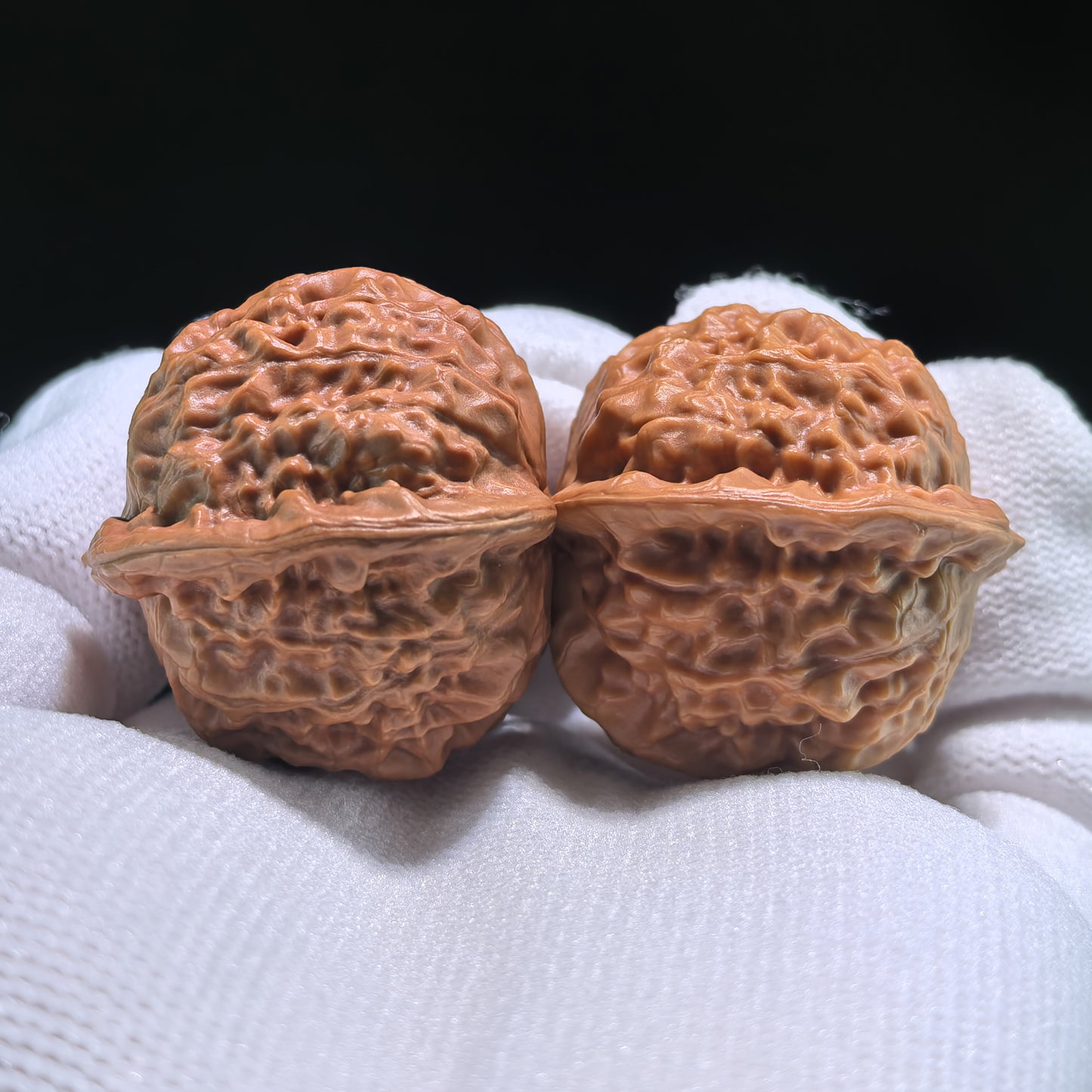 Pair of Walnut Hand Exercisers featuring porcelain doll and Guan Yin official seals, 35mm x 33mm, by ThePatinaProject.