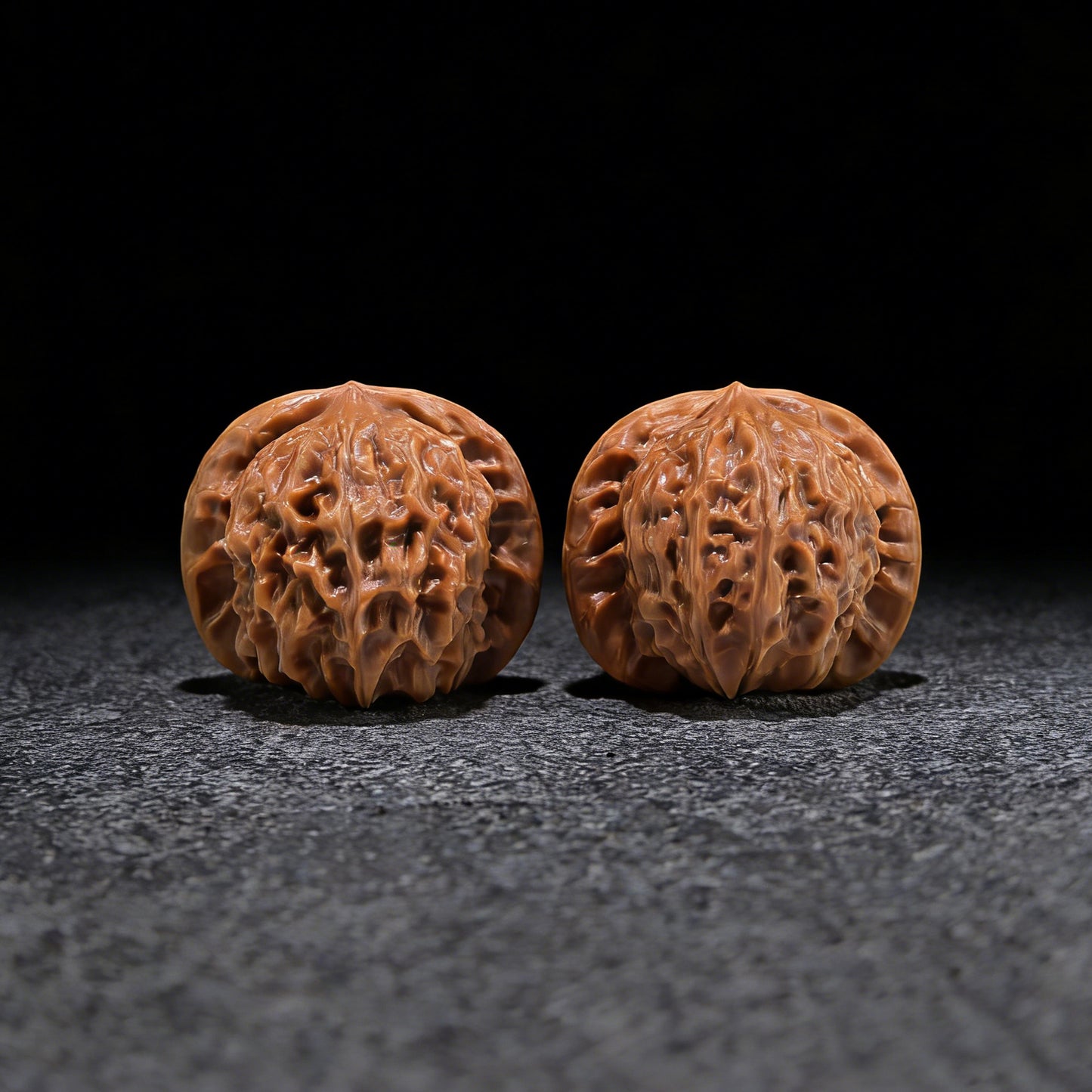 Pair of Walnut Hand Exercisers featuring porcelain doll seal design, size 37mm x 34mm, by ThePatinaProject.