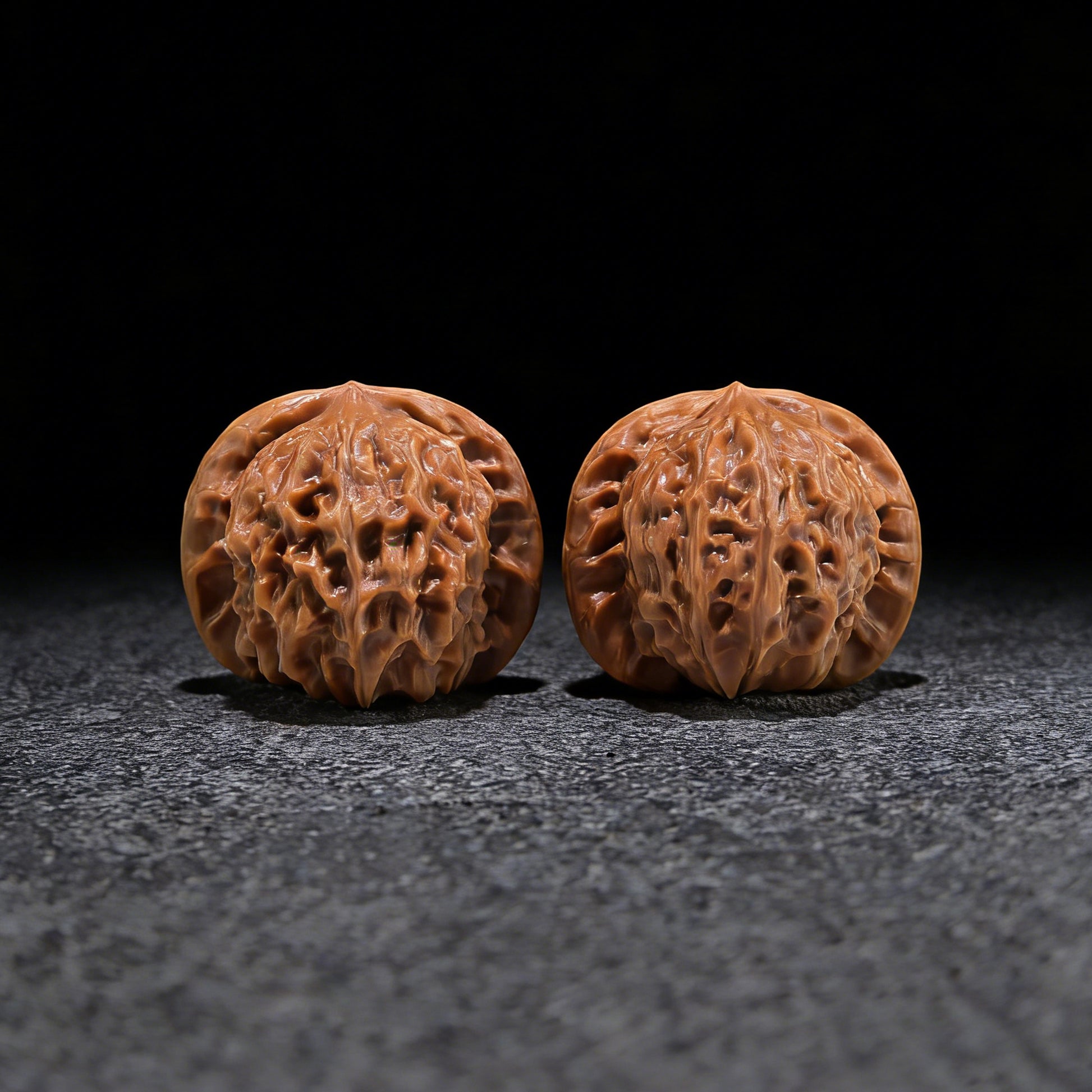 Pair of Walnut Hand Exercisers featuring porcelain doll seal design, size 37mm x 34mm, by ThePatinaProject.