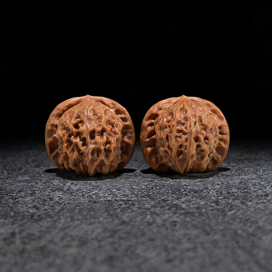 Pair of Walnut Hand Exercisers featuring porcelain doll seal design, size 37mm x 34mm, by ThePatinaProject.