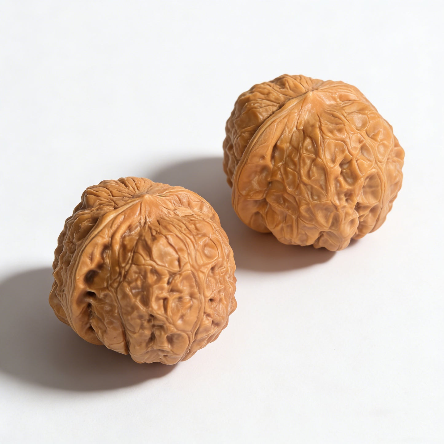 Pair of Walnut Hand Exercisers called Pumpkin Block by ThePatinaProject, 42mm x 44mm, featuring carved pumpkin design.
