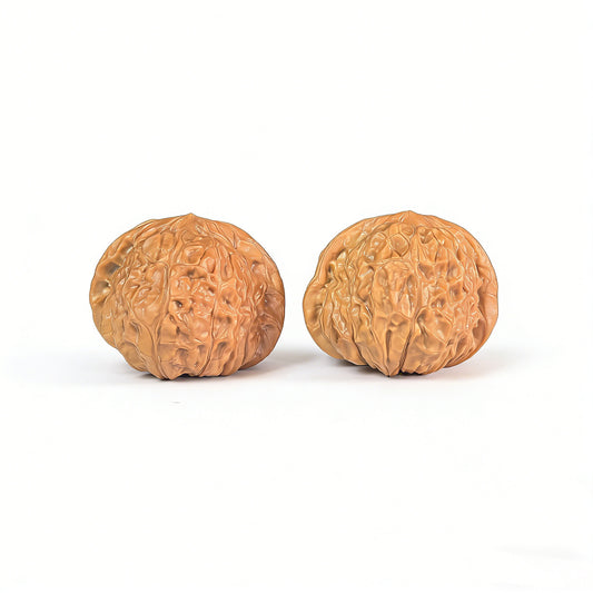 Pair of Walnut Hand Exercisers called Pumpkin Block (Nan Gua Dun) by ThePatinaProject, 42mm x 44mm, showing the textured wooden surface.